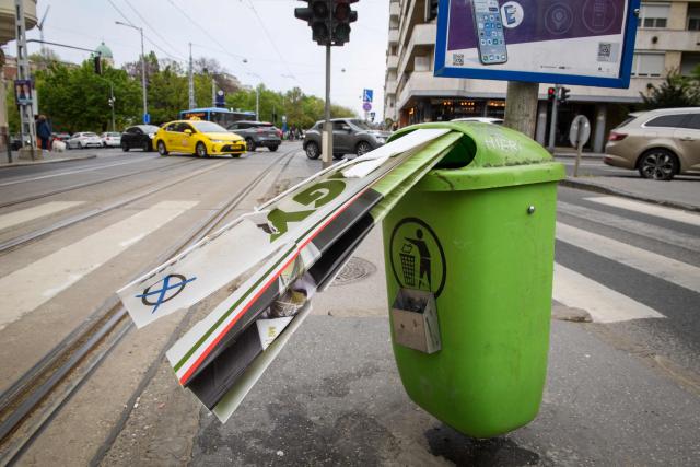 An election campaign poster of Hungarian far-right 'Our Homeland Movement' is seen stuffed in a trash can in Budapest, Hungary on April 13, 2026, one day after general elections. Hungarian prime minister-elect Peter Magyar pledged on April 13 to usher in a "new era" after defeating nationalist leader Viktor Orban in elections seen as a blow to hard-right populism. (Photo by Ferenc ISZA / AFP)