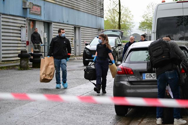 Forensic police carry evidence bags at the scene where a 13-year-old teenager was shot dead in the Belles Roches neighbourhood in Villefranche-sur-Saône, north of Lyon in southern central France, on April 13, 2026. Two minors aged 15 and 12 were taken into custody after the fatal shooting of a 13-year-old early afternoon in Villefranche-sur-Saône, prosecutors said, adding that an investigation for "murder" has been opened. (Photo by Olivier CHASSIGNOLE / AFP)