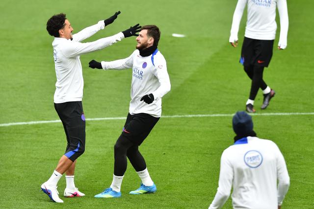 Paris Saint-Germain's Brazilian defender #05 Marquinhos (L) and Paris Saint-Germain's Georgian forward #07 Khvicha Kvaratskhelia (C) take part in a team training session at Anfield stadium in Liverpool, north-west England on April 13, 2026, on the eve of their UEFA Champions League, quarter final second leg football match against Liverpool. (Photo by PETER POWELL / AFP)