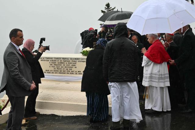 Pope Leo XIV stands in front of the memorial for the victims of the shipwrecks outside the Basilica of Our Lady of Africa after a meeting with the Algerian Community, in Algiers on April 13, 2026. Pope Leo XIV embarks today on an 11-day visit to Algeria, Cameroon, Angola and Equatorial Guinea for his first major international trip since becoming pontiff last year. (Photo by Alberto PIZZOLI / AFP)
