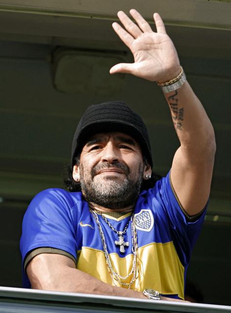 (FILES) In this file picture taken on August 6, 2006 former football star Diego Maradona wearing a jersey of Boca Juniors, waves as he cheers for the team before a match against Banfield during their first match of the Apertura 2006 Championship at La Bombonera stadium in Buenos Aires. The second trial for the death of Argentina's football legend Diego Maradona is scheduled to start on April 14, 2026 in Buenos Aires. (Photo by Juan MABROMATA / AFP)