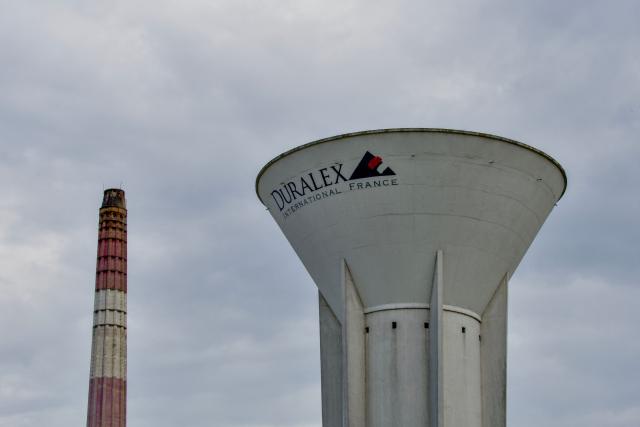 (FILES) This photograph shows a view of the French manufacturer of glassware Duralex' factory and the logo in La Chapelle-Saint-Mesmin near Orleans, centre France, on July 31, 2024. Duralex, the globally known glassmaker recently taken over as a cooperative by its employees, announced on April 13, 2026 the replacement of its chief executive. Officially presented as preparation for his retirement, the departure may in fact be linked to economic difficulties facing the company. (Photo by GUILLAUME SOUVANT / AFP)