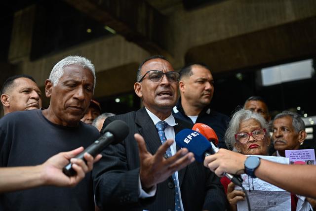 The lawyer of the workers' union, Eduardo Torres, speaks to the press during a protest against police crackdowns and for political freedoms outside the Ombudsman's Office in Caracas on April 13, 2026. (Photo by Federico PARRA / AFP)