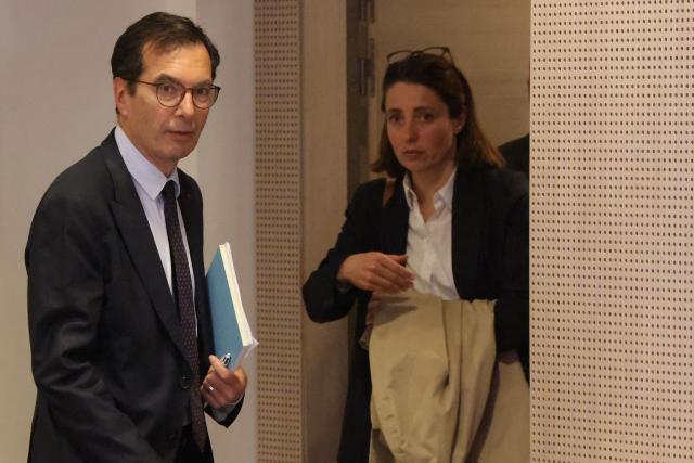 France's Labour Minister Jean-Pierre Farandou (L) leaves ahead of French trade union General Confederation of Labour (CGT) secretary general Sophie Binet (R) following a meeting with unions to discuss the proposed May 1st bill, in Paris on April 13, 2026. (Photo by Ludovic MARIN / AFP)