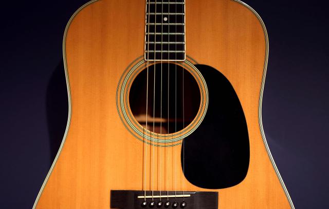 Bruce Springsteen’s Martin D-35 Acoustic Guitar, 1974—one of Bruce Springsteen’s principal instruments ca. 1975 through 1985 on display during a media preview at Sotheby’s Rock & Pop auction on April 13, 2026 in New York City, dedicated to objects and moments that have shaped classic rock and contemporary pop. The guitars are part of Sotheby's "Rock & Pop" sale taking place in April. (Photo by TIMOTHY A. CLARY / AFP)