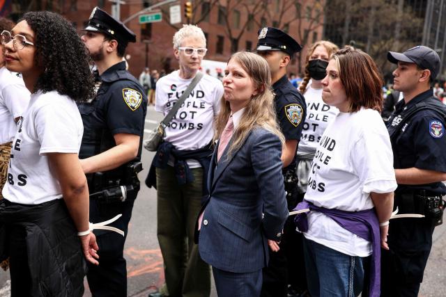 Activist Chelsea Manning (C) and other protesters are arrested by police during a demonstration and sit-in on Third Avenue in New York City on April 13, 2025. People gathered in front of the office of US Senate Minority Leader Chuck Schumer's office to protest against the war in Iran, Immigration and Customs Enforcement (ICE) and in support of Palestinians. (Photo by CHARLY TRIBALLEAU / AFP)