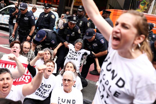 Protesters are arrested by police during a demonstration and sit-in on Third Avenue in New York City on April 13, 2025. People gathered in front of the office of US Senate Minority Leader Chuck Schumer's office to protest against the war in Iran, Immigration and Customs Enforcement (ICE) and in support of Palestinians. (Photo by CHARLY TRIBALLEAU / AFP)