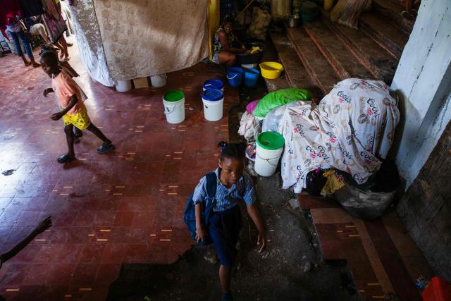 A young girl in school uniform, arrives to a shelter for displaced people at the Rex Theatre in downtown Port-au-Prince, Haiti, on April 13, 2026. (Photo by Clarens SIFFROY / AFP)