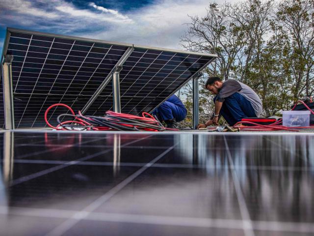 Solar panel specialists install solar panels on the rooftop of a multi-family building in Matanzas, Cuba, on April 13, 2026. (Photo by AFP)