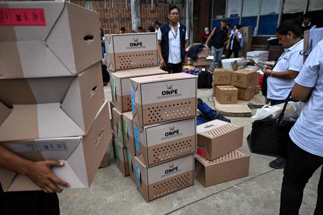 Election officials of Peru's National Office of Electoral Processes (ONPE) inspect electoral materials for registration and storage during the second day of the presidential election in Pucallpa, Peru on April 13, 2026. Two Peruvian right-wing candidates looked set on April 13, 2026, to advance to a presidential runoff, after an election marred by logistical foul-ups and deep voter anger. Voting is still underway at around a dozen polling places in Lima, where ballot materials failed to arrive on time for April 12 election. (Photo by Hugo Alejos / AFP)