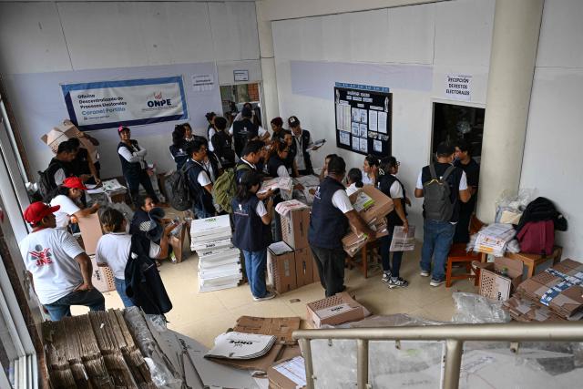 Election officials of Peru's National Office of Electoral Processes (ONPE) inspect electoral materials for registration and storage during the second day of the presidential election in Pucallpa, Peru on April 13, 2026. Two Peruvian right-wing candidates looked set on April 13, 2026, to advance to a presidential runoff, after an election marred by logistical foul-ups and deep voter anger. Voting is still underway at around a dozen polling places in Lima, where ballot materials failed to arrive on time for April 12 election. (Photo by Hugo Alejos / AFP)