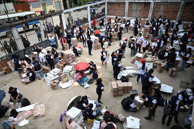 Election officials of Peru's National Office of Electoral Processes (ONPE) inspect electoral materials for registration and storage during the second day of the presidential election in Pucallpa, Peru on April 13, 2026. Two Peruvian right-wing candidates looked set on April 13, 2026, to advance to a presidential runoff, after an election marred by logistical foul-ups and deep voter anger. Voting is still underway at around a dozen polling places in Lima, where ballot materials failed to arrive on time for April 12 election. (Photo by Hugo Alejos / AFP)