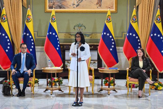 Venezuela's interim President Delcy Rodriguez (C) speaks next to Sectoral Vice President for Economy and Finance Calixto Ortega (L) and Minister of Petroleum and Hydrocarbons Paula Henao during a press conference after a signing of an agreement ceremony between Chevron Venezuela and the national government at the Miraflores Palace in Caracas on April 13, 2026. Venezuelas interim president, Delcy Rodriguez, praised on April 13 the progress made in the oil sector regarding foreign investment as part of the signing of agreements with the U.S. giant Chevron to increase crude oil production. (Photo by Juan BARRETO / AFP)