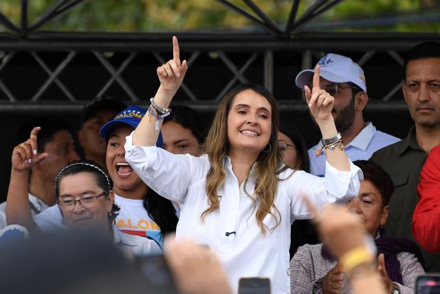 Colombia's presidential candidate Paloma Valencia (C), of the Centro Democratico party, gestures during a campaign rally in Rionegro, Antioquia department, Colombia, on April 13, 2026. The Colombian government reinforced security for opposition presidential candidate Paloma Valencia after she reported receiving death threats less than two months before the election. Colombia will hold presidential elections on May 31. (Photo by Jaime SALDARRIAGA / AFP)