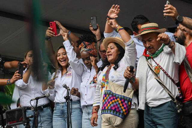 Colombia's vice-presidential candidate Aida Quilcue (C), for the Pacto Historico party, waves to supporters during a campaign rally in Cali, Valle del Cauca department, Colombia on April 13, 2026. Colombia will hold presidential elections on May 31. (Photo by JOAQUIN SARMIENTO / AFP)