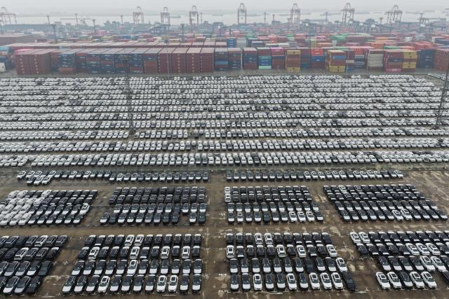 This aerial photo shows vehicles awaiting export at the port in Nanjing, in China’s eastern Jiangsu province on April 14, 2026. (Photo by CN-STR / AFP) / China OUT