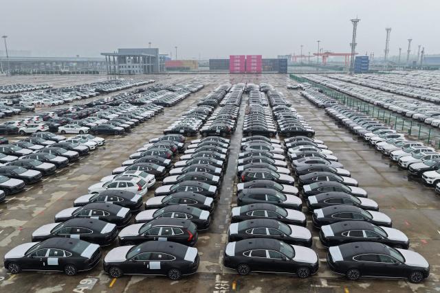 This aerial photo shows Volvo vehicles awaiting export at the port in Nanjing, in China’s eastern Jiangsu province on April 14, 2026. (Photo by CN-STR / AFP) / China OUT