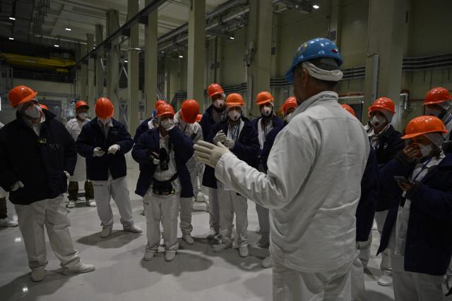 Representatives of Greenpeace and media visit at the New Safe Confinement at the Chornobyl Nuclear Power Plant on April 9, 2026, amid the Russian invasion of Ukraine. An uncontrolled collapse of the internal radiation shell at the defunct Chernobyl nuclear power station in Ukraine could increase the risk of radioactivity release in the environment, Greenpeace warned on April 14, 2026. (Photo by Genya SAVILOV / AFP)