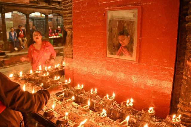 TOPSHOT - Hindu devotees lights oil lamps at Bal-Kumari temple to mark 'Bisket Jatra' festival held in celebration of the Nepalese New Year, in Thimi on April 14, 2026. (Photo by Prakash MATHEMA / AFP)