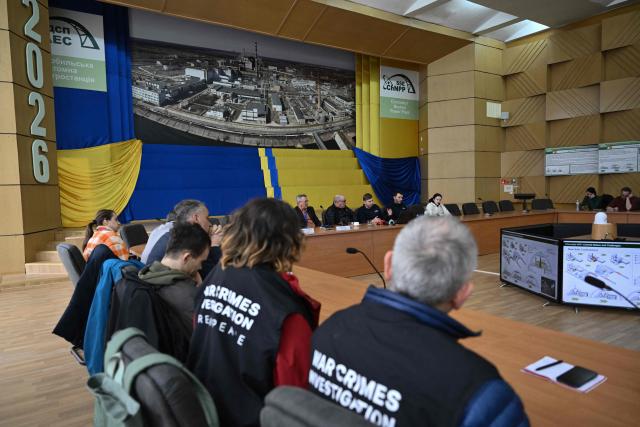 Director General of the Chernobyl Nuclear Power Plant Serhii Tarakanov (C-R), Chernobyl Nuclear Power Plant deputy technical director for radioactive waste management Oleksandr Skomarokhov (C-L) and senior nuclear specialist for Greenpeace Ukraine Shaun Burnie (C), attend a press conference at the Chernobyl Nuclear Power Plant on April 9, 2026, amid the Russian invasion of Ukraine. An uncontrolled collapse of the internal radiation shell at the defunct Chernobyl nuclear power station in Ukraine could increase the risk of radioactivity release in the environment, Greenpeace warned on April 14, 2026. (Photo by Genya SAVILOV / AFP)