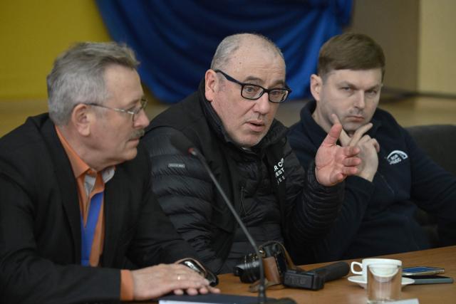 Director General of the Chernobyl Nuclear Power Plant Serhii Tarakanov (R) and Chernobyl Nuclear Power Plant deputy technical director for radioactive waste management Oleksandr Skomarokhov (L) listens to senior nuclear specialist for Greenpeace Ukraine Shaun Burnie (C), during a press conference at the Chernobyl Nuclear Power Plant on April 9, 2026, amid the Russian invasion of Ukraine. An uncontrolled collapse of the internal radiation shell at the defunct Chernobyl nuclear power station in Ukraine could increase the risk of radioactivity release in the environment, Greenpeace warned on April 14, 2026. (Photo by Genya SAVILOV / AFP)