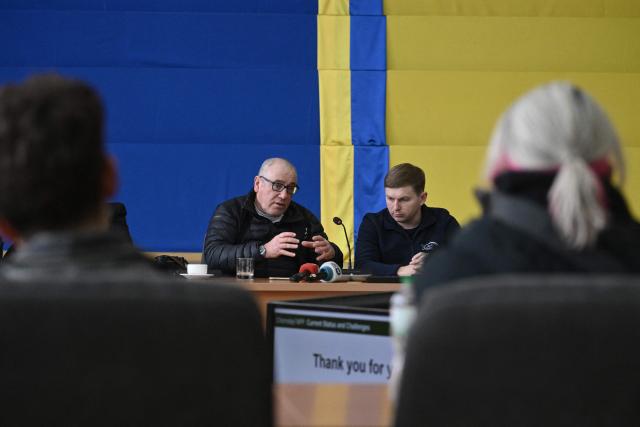 Director General of the Chernobyl Nuclear Power Plant Serhii Tarakanov (R) listens to senior nuclear specialist for Greenpeace Ukraine Shaun Burnie (L) during a press conference at the Chernobyl Nuclear Power Plant on April 9, 2026, amid the Russian invasion of Ukraine. An uncontrolled collapse of the internal radiation shell at the defunct Chernobyl nuclear power station in Ukraine could increase the risk of radioactivity release in the environment, Greenpeace warned on April 14, 2026. (Photo by Genya SAVILOV / AFP)