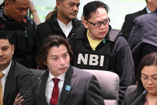 Ramil Madriaga (back, R) wearing a bullet proof vest, arrives at the impeachment hearing of Philipine Vice-President Sara Duterte at the House of Representatives in Quezon City, suburban Manila on April 14, 2026. A Philippine congressional committee agreed overwhelmingly on March 4,to advance the impeachment case against Duterte, setting the stage for the poterntial vote that could decide her political future. (Photo by Ted ALJIBE / AFP)