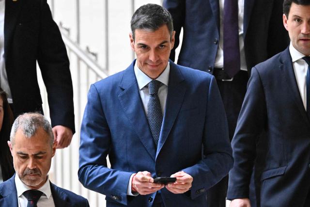 Spain's Prime Minister Pedro Sanchez (C) leaves after holding a press conference in Beijing on April 14, 2026, following a meeting with China's President Xi Jinping. Sanchez urged reform to make the world order "more representative" after talks with Chinese President Xi Jinping in Beijing. (Photo by Pedro PARDO / AFP)