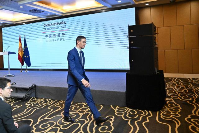 Spain's Prime Minister Pedro Sanchez (C) leaves after holding a press conference in Beijing on April 14, 2026, following a meeting with China's President Xi Jinping. Sanchez urged reform to make the world order "more representative" after talks with Chinese President Xi Jinping in Beijing. (Photo by Pedro PARDO / AFP)