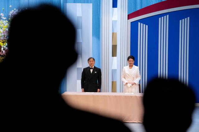 Japan’s Emperor Naruhito (L) and Empress Masako stand for the national anthem during the Japan Prize presentation ceremony in Tokyo on April 14, 2026. (Photo by Yuichi YAMAZAKI / AFP)