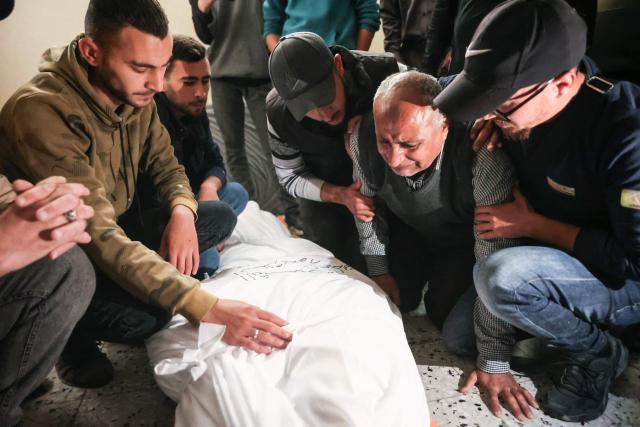 Palestinian mourners react during the funeral of Islam Quneita, a writer and managing editor for the website "Palestine Now", who according to medic was killed in an Israeli strike the day before, in Gaza City, on April 14, 2026. Gaza is still reeling from more than two years of war between Israel and Hamas, sparked by the militant group's October 7, 2023, attack on Israel. (Photo by Omar AL-QATTAA / AFP)