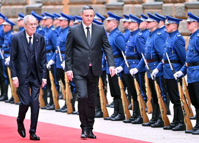 President of Austria Alexander Van der Bellen (R) and Chairman of the Presidency of Bosnia and Herzegovina Denis Becirovic inspect a Bosnian honor guard, during a welcoming ceremony, in Sarajevo on April 14, 2026. President Van der Bellen arrived in a 2-day official visit to Bosnia and Herzegovina. (Photo by ELVIS BARUKCIC / AFP)