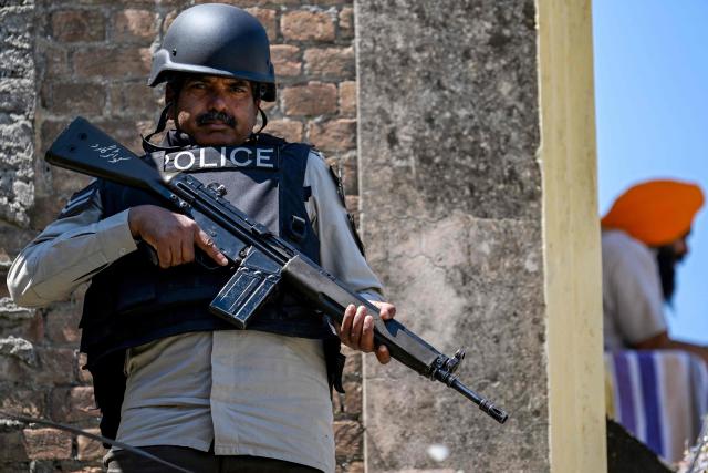 A police personnel stands guard at the Gurdwara Panja Sahib on the occasion of the spring harvest Sikh festival 'Baisakhi' in Hasan Abdal on April 14, 2026. (Photo by Aamir QURESHI / AFP)