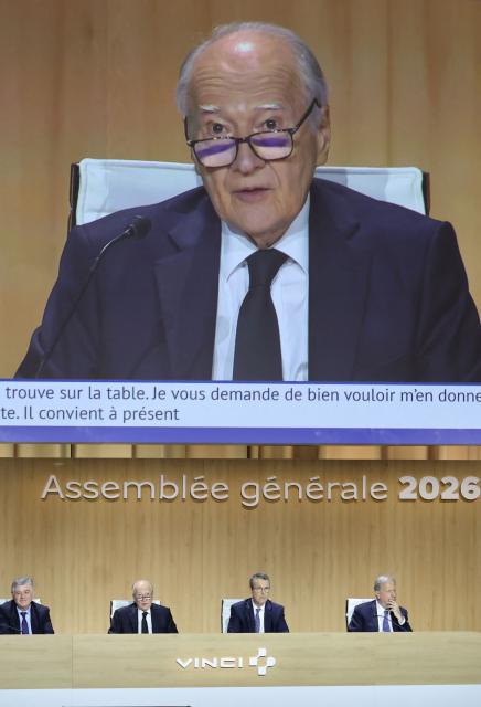 Vinci chief executive Xavier Huillard (2ndL) addresses shareholders next to Vinci chief executive Pierre Anjolras (2ndR) during the general meeting of infrastructure group Vinci in Paris on April 14, 2026. (Photo by Ludovic MARIN / AFP)
