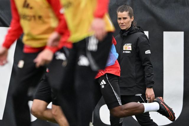 Union Berlin's new German head coach Marie-Louise Eta watches players during a training session of German first division Bundesliga football club 1 FC Union Berlin in Berlin on April 14, 2026. Bundesliga club Union Berlin named Marie-Louise Eta as head coach, making her the first female manager of a men's team in a top-five European league, after former mentor Steffen Baumgart was sacked. The 34-year-old will take over for the remainder of the season. (Photo by RALF HIRSCHBERGER / AFP)