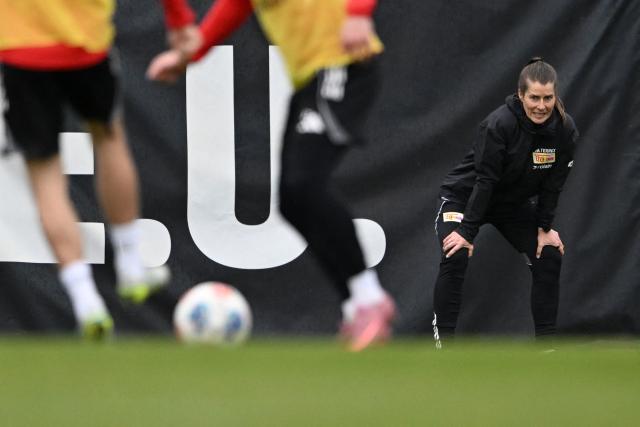 Union Berlin's new German head coach Marie-Louise Eta watches players during a training session of German first division Bundesliga football club 1 FC Union Berlin in Berlin on April 14, 2026. Bundesliga club Union Berlin named Marie-Louise Eta as head coach, making her the first female manager of a men's team in a top-five European league, after former mentor Steffen Baumgart was sacked. The 34-year-old will take over for the remainder of the season. (Photo by RALF HIRSCHBERGER / AFP)