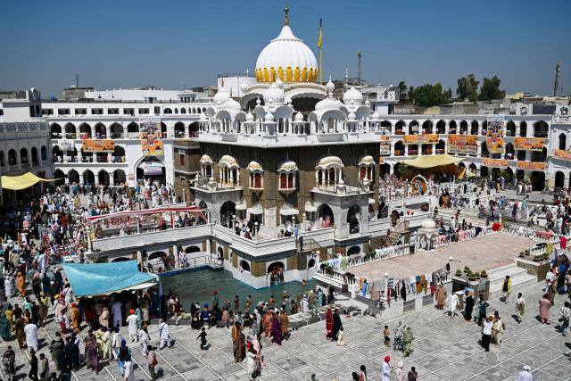 Sikh pilgrims gather to pay their respects on the occasion of the spring harvest festival 'Baisakhi' at the Gurdwara Panja Sahib in Hasan Abdal on April 14, 2026. (Photo by Aamir QURESHI / AFP)