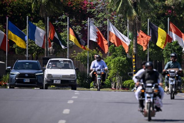 Motorists ride past Serena Hotel, the venue where Iran and the United States held peace talks earlier in Islamabad on April 14, 2026. As the clock ticked down to US President Donald Trump's deadline to destroy Iran's civilisation last week, hope emerged from an unlikely corner, with Pakistan's prime minister first seeking -- and within hours securing -- a two-week ceasefire between the warring sides. (Photo by Farooq NAEEM / AFP)