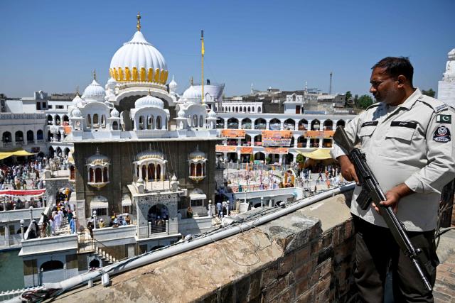A security personnel stands guard at the Gurdwara Panja Sahib on the occasion of the spring harvest Sikh festival 'Baisakhi' in Hasan Abdal on April 14, 2026. (Photo by Aamir QURESHI / AFP)