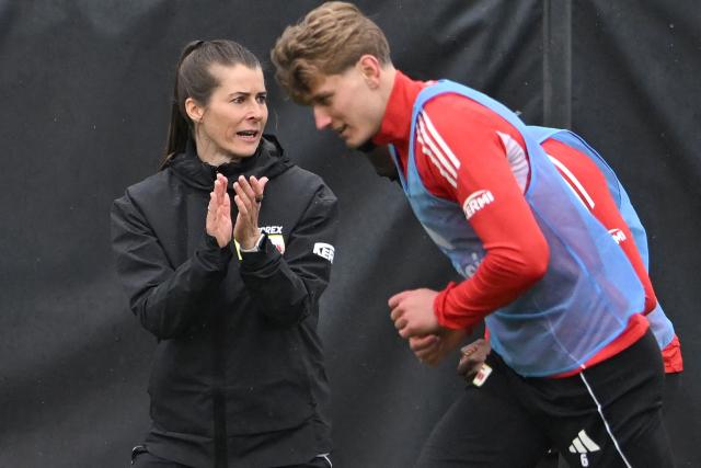 Union Berlin's new German head coach Marie-Louise Eta (L) reacts as Union Berlin's German midfielder #06 Aljoscha Kemlein attends a training session of German first division Bundesliga football club 1 FC Union Berlin in Berlin on April 14, 2026. Bundesliga club Union Berlin named Marie-Louise Eta as head coach, making her the first female manager of a men's team in a top-five European league, after former mentor Steffen Baumgart was sacked. The 34-year-old will take over for the remainder of the season. (Photo by RALF HIRSCHBERGER / AFP)