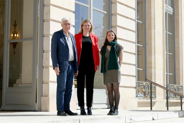 The President of the National Assembly Yael Braun-Pivet (C) poses with French nationals Cecile Kohler (R) and Jacques Paris (L) upon their arrival for a ceremony to removed their portraits hanged in their honour on the National Assembly gates when they were still held hostages in Iran, at the National Assembly, French Parliament lower house, in Paris on April 14, 2026. Cecile Kohler, 41, and Jacques Paris, 72, arrested on espionage charges, were imprisoned for three years before being sent to house arrest at the French embassy in November 2026. (Photo by Alain JOCARD / AFP)