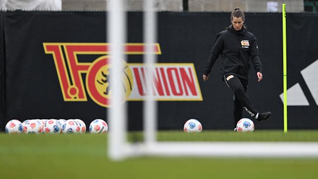 Union Berlin's new German head coach Marie-Louise Eta plays the ball during a training session of German first division Bundesliga football club 1 FC Union Berlin in Berlin on April 14, 2026. Bundesliga club Union Berlin named Marie-Louise Eta as head coach, making her the first female manager of a men's team in a top-five European league, after former mentor Steffen Baumgart was sacked. The 34-year-old will take over for the remainder of the season. (Photo by RALF HIRSCHBERGER / AFP)