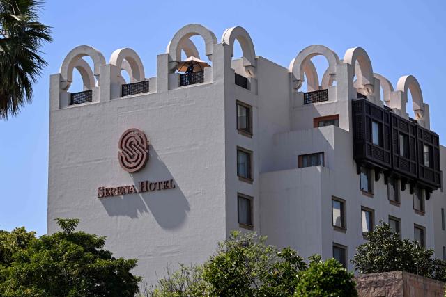 A security guard stands atop the Serena Hotel, the venue where Iran and the United States held peace talks earlier in Islamabad on April 14, 2026. As the clock ticked down to US President Donald Trump's deadline to destroy Iran's civilisation last week, hope emerged from an unlikely corner, with Pakistan's prime minister first seeking -- and within hours securing -- a two-week ceasefire between the warring sides. (Photo by Farooq NAEEM / AFP)