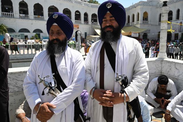 Sikh pilgrims gather to pay their respects on the occasion of the spring harvest festival 'Baisakhi' at the Gurdwara Panja Sahib in Hasan Abdal on April 14, 2026. (Photo by Aamir QURESHI / AFP)