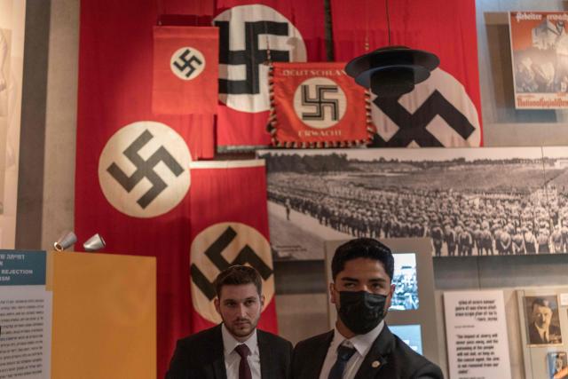 Security personal stand at the Yad Vashem Holocaust Memorial Museum in Jerusalem during the annual Holocaust Remembrance Day on April 14, 2026. Israel came to a standstill on April 14, as sirens sounded across the country in tribute to the six million Jews murdered by the Nazis during World War II. This year's commemoration comes amid a fragile two-week ceasefire with Iran after a deadly war that began on February 28, when a joint US-Israeli air attack killed Iran's supreme leader (Photo by Ilia YEFIMOVICH / AFP)