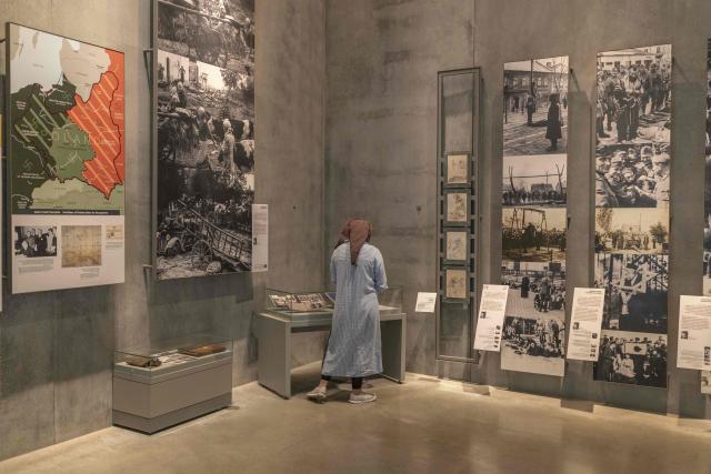 An Israeli woman visits the Yad Vashem Holocaust Memorial Museum in Jerusalem during the annual Holocaust Remembrance Day on April 14, 2026. Israel came to a standstill on April 14, as sirens sounded across the country in tribute to the six million Jews murdered by the Nazis during World War II. This year's commemoration comes amid a fragile two-week ceasefire with Iran after a deadly war that began on February 28, when a joint US-Israeli air attack killed Iran's supreme leader (Photo by Ilia YEFIMOVICH / AFP)
