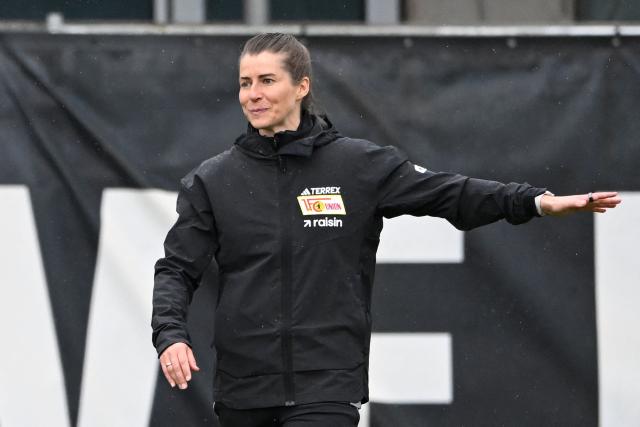 Union Berlin's new German head coach Marie-Louise Eta gestures as she speaks with players during a training session of German first division Bundesliga football club 1 FC Union Berlin in Berlin on April 14, 2026. Bundesliga club Union Berlin named Marie-Louise Eta as head coach, making her the first female manager of a men's team in a top-five European league, after former mentor Steffen Baumgart was sacked. The 34-year-old will take over for the remainder of the season. (Photo by RALF HIRSCHBERGER / AFP)