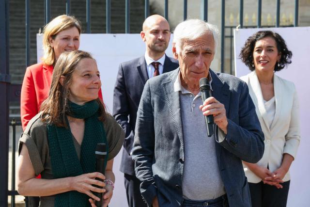 (First row from L) French nationals Cecile Kohler and Jacques Paris speak in front of (second row from L) The President of the National Assembly Yael Braun-Pivet, France's Foreign Affairs Minister Jean-Noel Barrot and Socialistes et Apparentes' MP Ayda Hadizadeh  during a ceremony to remove their portraits hanged in their honour on the National Assembly gates when they were still held hostages in Iran, at the National Assembly, French Parliament lower house, in Paris on April 14, 2026. Cecile Kohler, 41, and Jacques Paris, 72, arrested on espionage charges, were imprisoned for three years before being sent to house arrest at the French embassy in November 2026. (Photo by ALAIN JOCARD / AFP)