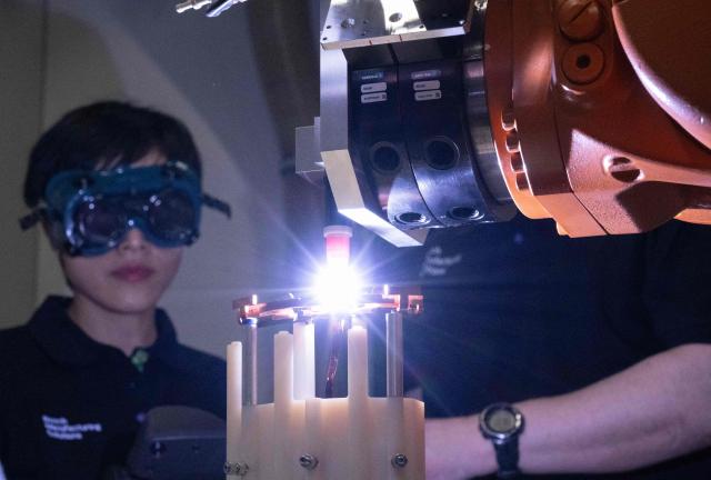 Employees of Bosch Manufacturing Solutions control copper welding in the eDrive Lab in Stuttgart, southern Germany, on April 14, 2026. The eDrive Lab optimizes the manufacturing steps for serial production of electric drives. Bosch will hold its annual press conference on April 16, 2026. (Photo by THOMAS KIENZLE / AFP)