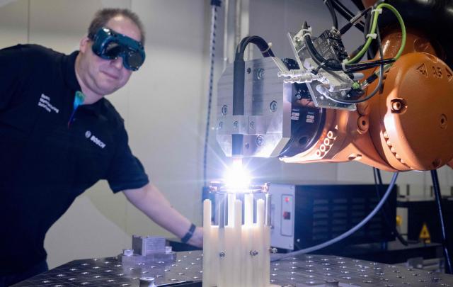 An employee of Bosch Manufacturing Solutions controls copper welding in the eDrive Lab in Stuttgart, southern Germany, on April 14, 2026. The eDrive Lab optimizes the manufacturing steps for serial production of electric drives. Bosch will hold its annual press conference on April 16, 2026. (Photo by THOMAS KIENZLE / AFP)